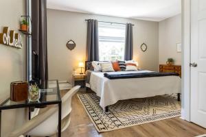 a bedroom with a bed and a glass table at Modern, Rustic Farmhouse Apartment near Downtown in Mount Clemens
