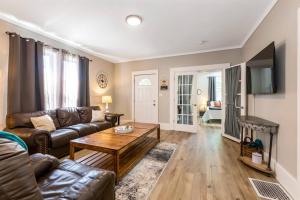a living room with a couch and a coffee table at Modern, Rustic Farmhouse Apartment near Downtown in Mount Clemens