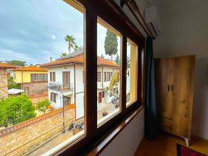 a window with a view of a building at Ali Apart in Antalya