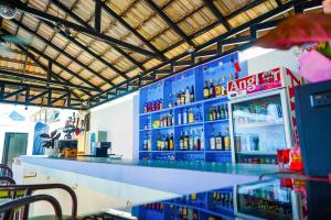 a bar with a lot of bottles of alcohol at Angkor Sunshine Oasis in Siem Reap