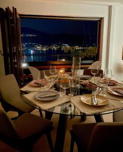 a table with wine glasses and a view of the city at Villa Christina 2 in Ohrid