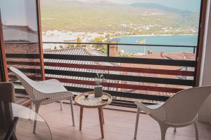 a balcony with chairs and a table and a view at Villa Christina 2 in Ohrid