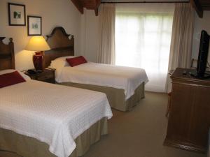 Cama ou camas em um quarto em Hotel Posada Los Alamos