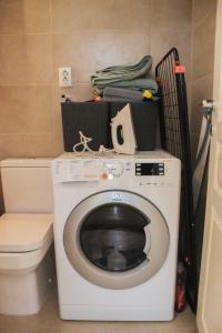 a washing machine in a bathroom with a toilet at Villa Christina 2 in Ohrid