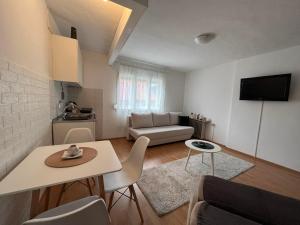 a small living room with a table and a couch at Sunlight Apartments in Mostar