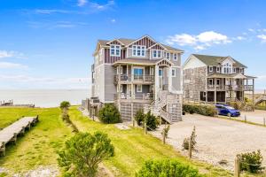 a large house on a hill next to the ocean at Launch 41 in Waves
