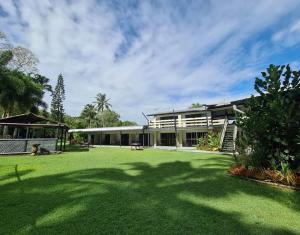 an exterior view of a building with a large yard at Bramston beach resort in Bramston Beach