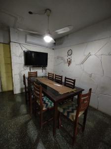 Cette chambre dispose d'une table, de chaises et d'une télévision. dans l'établissement Como en casa Hostel, à Posadas