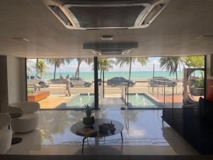 a living room with a view of the ocean at Unity - Cabo Branco by Jess in João Pessoa
