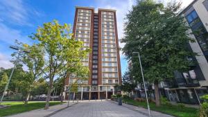 a tall building with a street in front of it at 13 Clifton Court - Lovely 2 bedroom flat with patio in Finsbury Park in London
