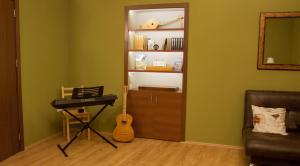 a small room with a guitar and a guitar case at Pushkin 10 Hostel in Tbilisi City