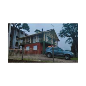 a house with a car parked in front of it at Residencial Recanto Verde in Canela