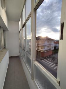 a room with a window with a view of a building at HORIZON in Arzúa