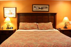 a bedroom with a large bed with two lamps at Condo 7 Slopeside With Private Sauna and Hot Tub in Killington