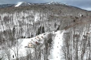 a ski lodge in the snow on a mountain at Condo 7 Slopeside With Private Sauna and Hot Tub in Killington