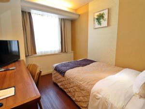 Postel nebo postele na pokoji v ubytování Tottori Onsen Hotel Monarque Tottori