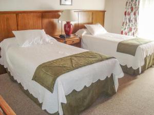 Cama ou camas em um quarto em Hotel Posada Los Alamos