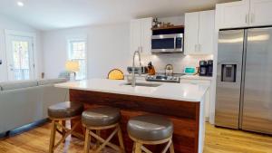 a kitchen with a sink and a refrigerator at Modern 2BR 2BA with King bed-Fast Wi-Fi 75 inch OLED TV in Wilmington