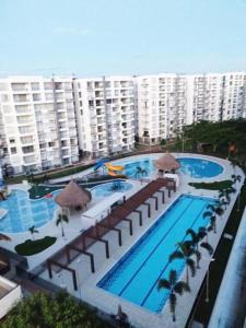 an overhead view of a large swimming pool with buildings at Marquis Enclave, Condo With Pool Access and More in Ricaurte