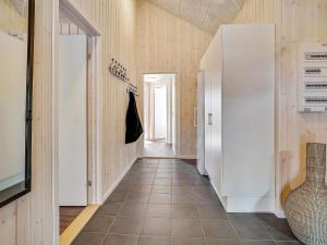 a hallway with white cabinets and a tile floor at Luxury Pool Villa in Grena - By Traum Ferienwohnungen in Grenå +38 photos