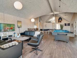 a living room with couches and a pool table at Luxury Pool Villa in Grena - By Traum Ferienwohnungen in Grenå