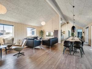 a living room with a couch and a table and chairs at Holiday home Grenaa XVIII in Grenå
