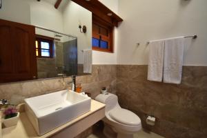 a bathroom with a sink and a toilet and a mirror at Hotel Campanario Real in Villa de Leyva +42 photos