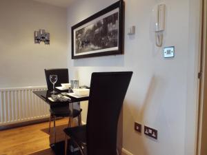 a dining room with a table and two chairs at Mill Wharf in Berwick-Upon-Tweed