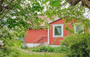a red house with a staircase in front of it at Lovely Home In Degerhamn With Kitchen in Degerhamn