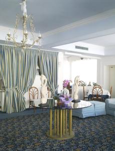 a living room with a couch and a table with statues on it at Hotel Maremonti in Gabicce Mare