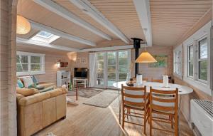 a living room with a couch and a table at Holiday Home H in Højby