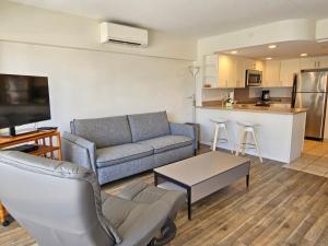 a living room with a couch and a kitchen at Ilikai Tower 1340 Lagoon View 1BR in Honolulu