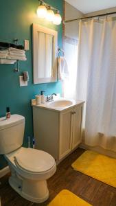 a bathroom with a white toilet and a sink at Franklin Park 3BR Condo near Airport, Downtown, OSU in Columbus