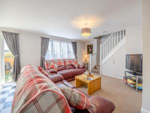 a living room with a couch and a tv at Willows Cottage - Uk42144 in North Somercotes