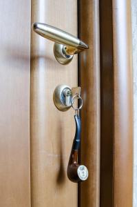 a locking door with a key in it at Baker Street Hotel in Nizhny Novgorod