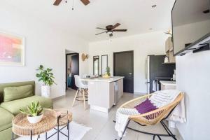a living room with a couch and a table at Bright & Airy new Condo, 5 min walk to Jaco Beach! in Jacó