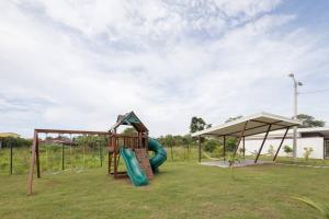 a park with a playground with a slide at Bright & Airy new Condo, 5 min walk to Jaco Beach! in Jacó
