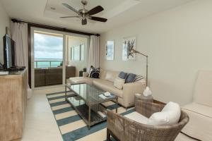 uma sala de estar com um sofá e uma mesa em Grand Caribe Belize em San Pedro