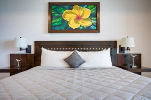 a bedroom with a large bed with two night stands at Grand Caribe Belize in San Pedro