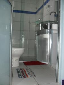 a bathroom with a sink and a toilet at Pousada Azul in Canoa Quebrada