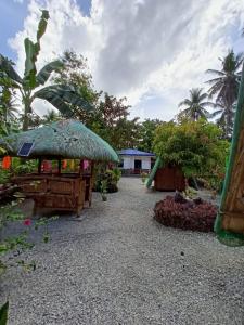 a garden with a pavilion and a playground at Jodels Paradise in Ligao