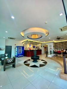 a lobby with a fountain in the middle of a building at Best View Hotel Sunway Mentari in Petaling Jaya