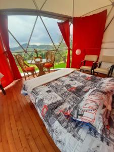 1 dormitorio con 1 cama y 1 mesa en una tienda de campaña en Glamping Mi Casita en Guatavita