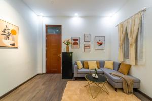 a living room with a couch and a table at NM Homestay Danang in Da Nang