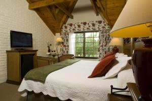 Cama ou camas em um quarto em Hotel Posada Los Alamos
