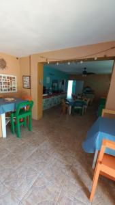 a living room with tables and chairs and a kitchen at Castaways Villa in Duncans