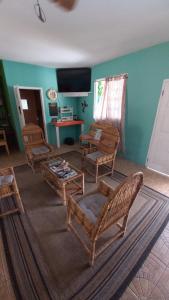 a living room with chairs and a table at Castaways Villa in Duncans