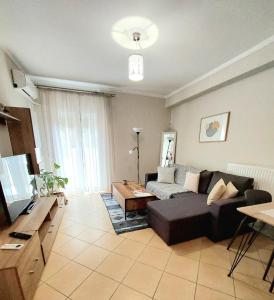 salon z kanapą i stołem w obiekcie Elpida's house w mieście Spata