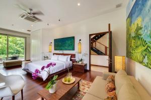 une chambre avec un lit et un salon dans l'établissement The Luxe Bali - Luxury 4 Bedroom Cliff Ocean Edge Villa Uluwatu, à Uluwatu 65 autres photos
