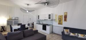 a living room with a couch and a kitchen at La Villa di Nonna Pina in Balestrate